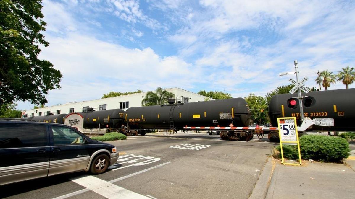 A train carrying 98 tankers of crude oil passes through midtown Sacramento.