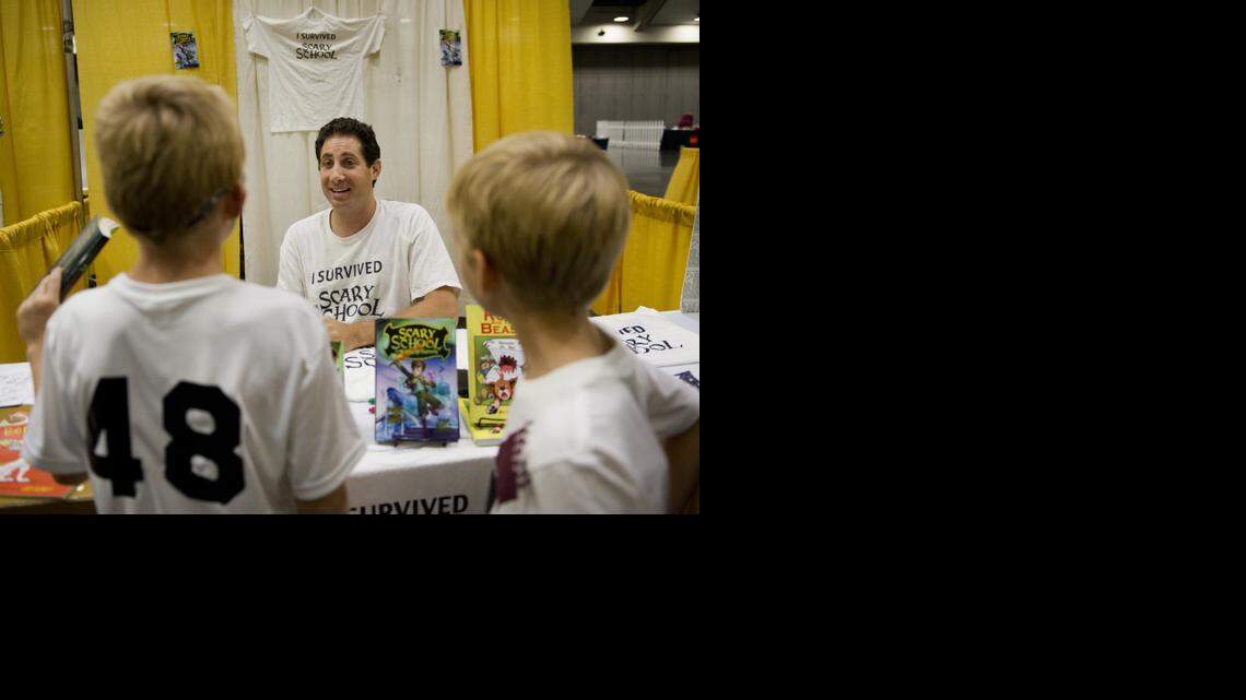 
Derek Taylor Kent, who writes a series of books called Scary School as “Derek the Ghost” talks with Owen Osborn, 10, left, and his brother, Oliver Osborn, 6, Saturday at the California Capitol Book Festival at the Sacramento Convention Center. The series is aimed at children 7-12.  The festival, which is free to the public, will be open again on Sunday, October 26 from 11am-5pm.
