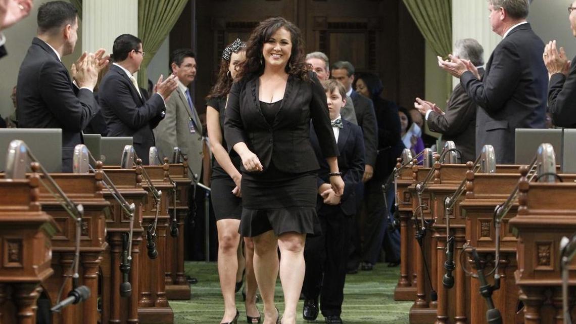 Lorena Gonzalez, D-San Diego, receives applause from lawmakers as she walks down the center isle of the Assembly to take the oath of office at the Capitol in Sacramento, Calif., Tuesday, May 28, 2013. (AP Photo/ Rich Pedroncelli)