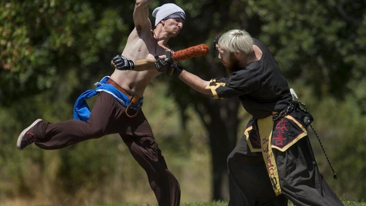 Amtgard players Brooklynn Overton, 22, of Citrus Heights, left, and Robert Mott Jr., 21, of North Highlands battle briefly at Howe Park in Sacramento on Saturday, Aug. 6, 2016.