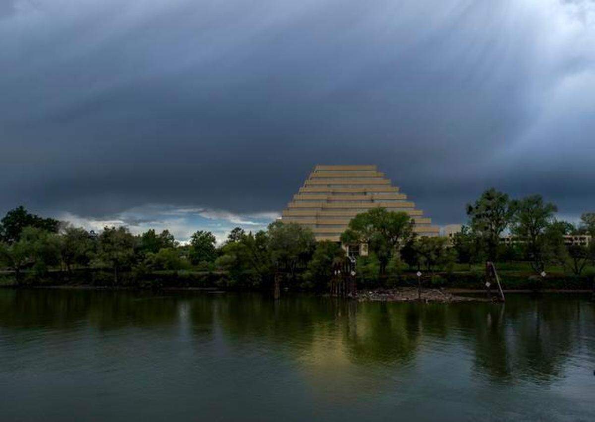 Storm clouds overshadow the blue sky above the pyramid shaped ziggurat building as rain and hail fell in West Sacramento in 2015.