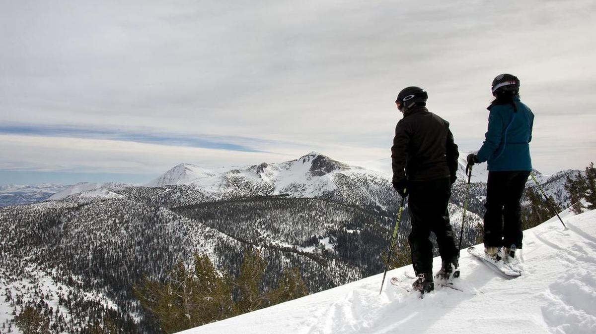 Two skiers at Heavenly Valley ski resort pause on a ridge line overlooking the Sierra Nevada mountains toward the south as high clouds move into the mountains on Tuesday, January 17, 2017 in South Lake Tahoe, Calif. Another storm is expected to hit Northern California Wednesday, the first of a series of storms through the weekend.