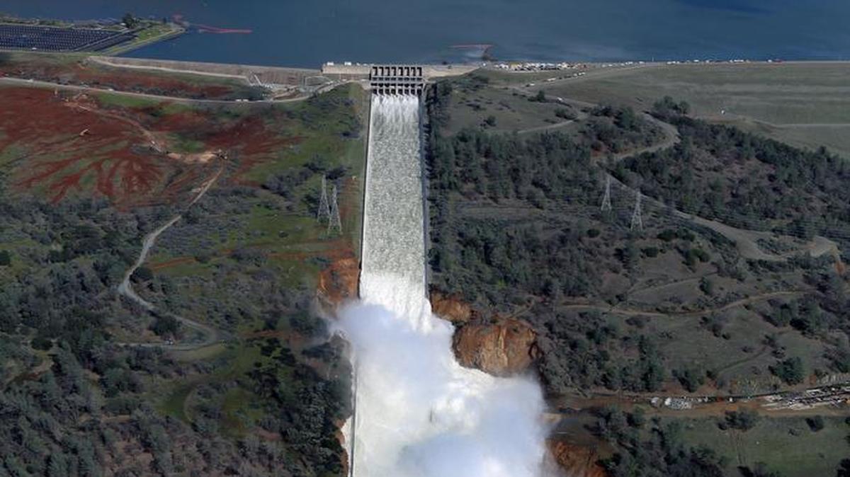 Water flows down the damaged spillway Saturday, Feb. 11, 2017, at Oroville Dam