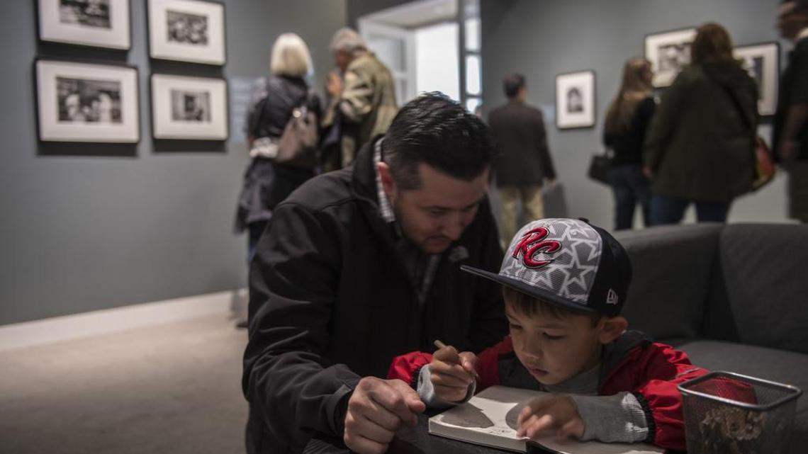 “My Bachan & Grandpa were born in the internment camp,” wrote Mason Laurel, 6, in a guest book inside the exhibition Two Views: Photographs by Ansel Adams and Leonard Frank on Thursday, Feb,19, 2017 in Sacramento, Calif., at the Crocker Art Museum. Bachan is slang for grandmother, derived from the Japanese word obaasan. Mason and his father Aaron Laurel, left, are from West Sacramento.