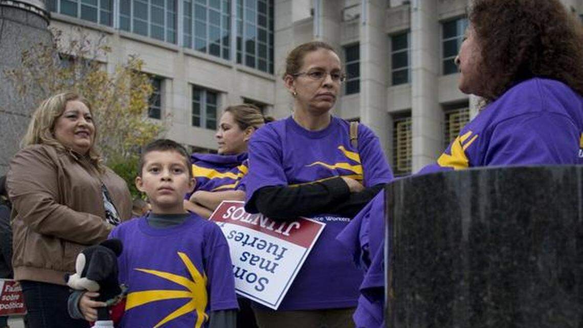 
Vicente Juarez, 9, of Sacramento attends a rally downtown in support of President Obama’s immigration order Friday with his mother, Luz Davila, second from right, who said the boy’s father will benefit from the action. 
