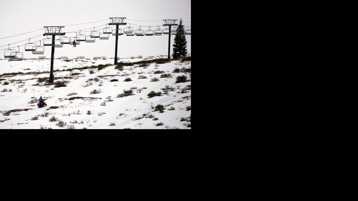 
A skier rides up the Eagle Rock chairlift to the summit at Tahoe Donner ski area in January. The run below the chairlift, and many others have been closed due to lack of snowfall. Sierra at Tahoe has announced it is closing, at least temporarily. It is the fifth of 14 operators closing early due to lack of snow.
