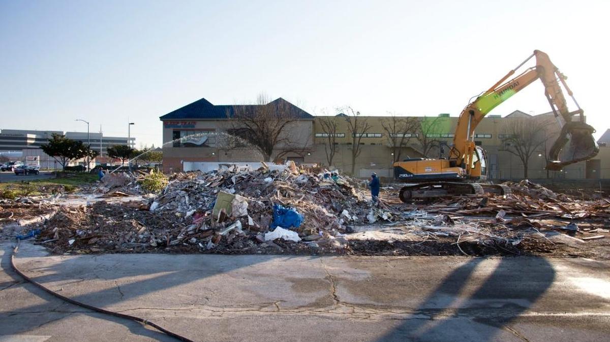Workers sort through debris at the former Motel 6 – site of the recent fatal shooting of a Sacramento county deputy – which is being leveled to make way for a new shopping complex on Friday, Jan. 30, 2015 in Sacramento, Calif. City and county officials are seeking to impose strict conditions on all Motel 6 properties in Sacramento County.