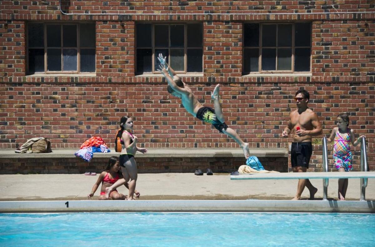 Kids and adults enjoy the day at the Clunie Community Pool at McKinley Park, Wednesday, July 9, 2014.