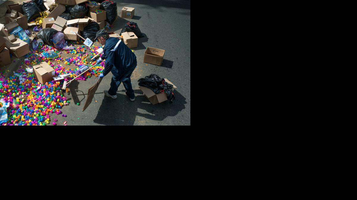 
Easter eggs are collected by Vasiliy Smolikov of Sacramento on Monday, after thousands were left at Capitol Mall from an egg hunt on Saturday that failed to break a world record of 501,000 set in 2007 in Florida.
