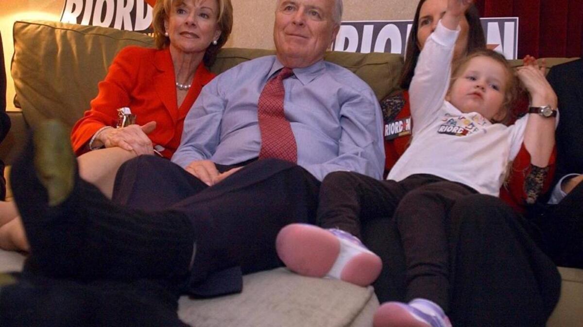 Former Los Angeles Mayor Richard Riordan relaxes on a couch in his room at the Weston LAX while he and his family members wait for early election returns on March 5, 2002. At left is his wife Nancy Daly. At right is his daughter Tricia Torrey and Riordan's grandaughter Jessica Torrey, 3. The Sacramento Bee / Randy Pench