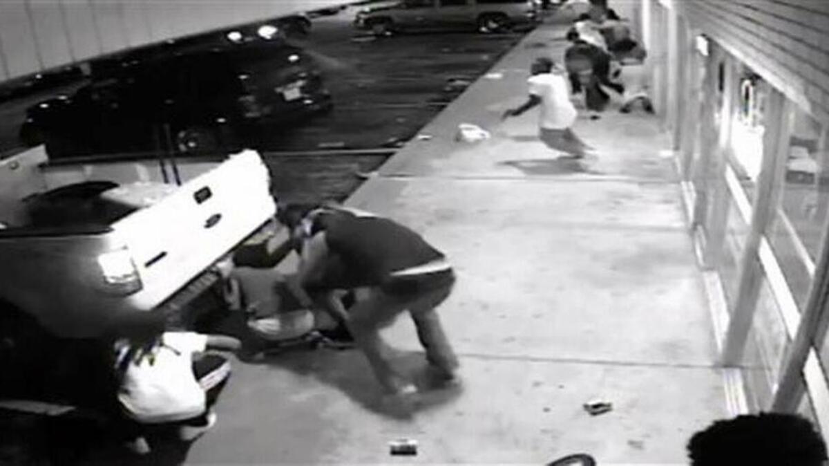 
In this Aug. 9, 2015, frame from surveillance video provided by the St. Louis County Police shows the 18-year-old black suspect, center in light colored clothes, minutes before he fired a gun at plainclothes officers in Ferguson, Mo. Tyrone Harris Jr. was shot late Sunday after police say he opened fire on an unmarked police van. The shooting happened as protesters nearby were marking the anniversary of the shooting death of Michael Brown, who was killed by a white police officer. 
