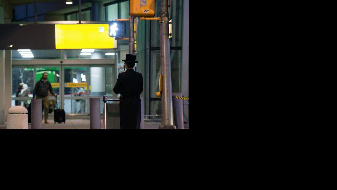 An ultra-Orthodox Jewish man walks at Kennedy airport in New York in February. Airline passengers are telling of conflicts between women and ultra-Orthodox men with seats next to them.