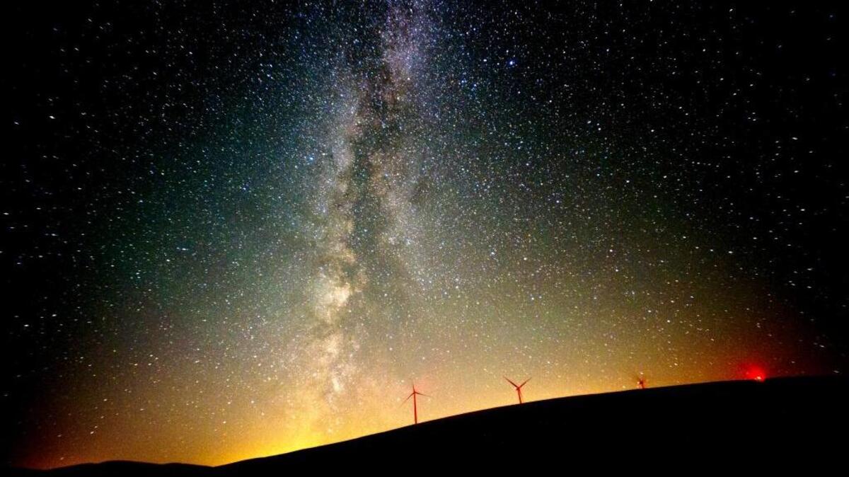 The Milky Way lights up the Pacific Northwest sky during the Perseid Meteor Shower Friday morning, Aug. 12, 2016 by the wind mills located north of Dayton, Wash.