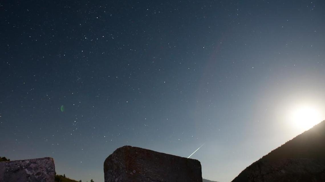 Stars and meteor streaks (near the line of horizon) are seen behind a medieval tombstone, believed to be built around 12th century depicting the ancient ritual dance, on the mountain Bjelasniaca, near the village of Umoljani, 50 kilometers (31 miles) southeast of Sarajevo, Bosnia, late Friday, Aug. 11, 2017. The annual Perseid meteor shower will reach its peak on Saturday night.
