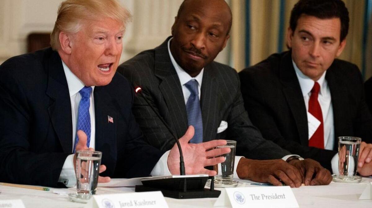 President Donald Trump, left, speaks during a meeting with manufacturing executives at the White House in Washington, including Merck CEO Kenneth Frazier, center, and Ford CEO Mark Fields, in February.