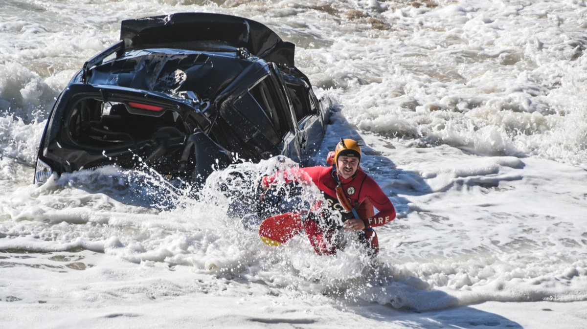 Rescue swimmers arrived in the area after getting a call about a car going over a cliff, Santa Cruz fire officials say.