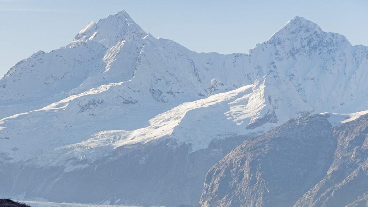 The “stunning scenery” of a pod of sea creatures swimming against the dramatic backdrop of snow-capped peaks in Glacier Bay National Park and Preserve “filled everyone with awe.”
