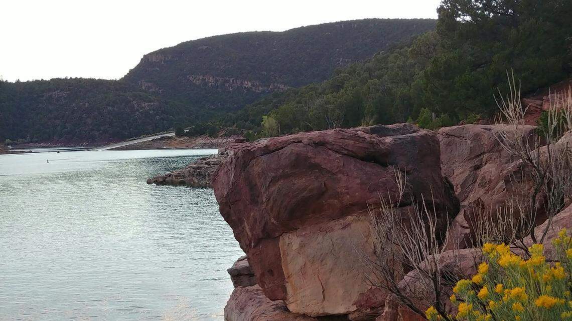 A woman remains missing after trying to save her 60-year-old mother in a fatal paddle-boarding accident at Flaming Gorge Reservoir, Utah officials say.