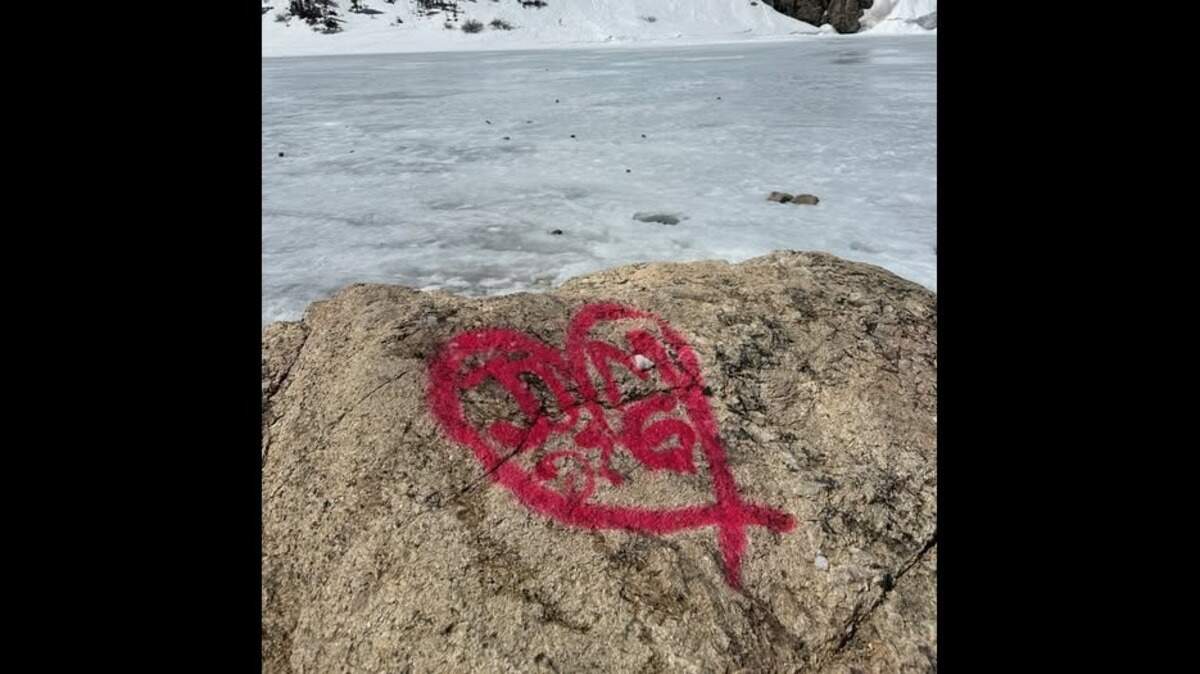 Authorities are searching for a couple who spray-painted their initials on a rock in a Colorado national forest.