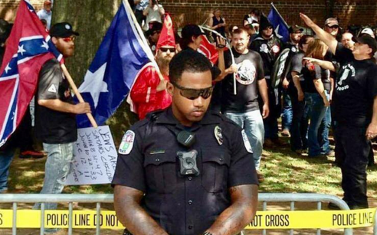A photo being posted online after deadly violence in Charlottesville, Va., of a black police officer protecting a white nationalist rally appears to have been from an earlier event.