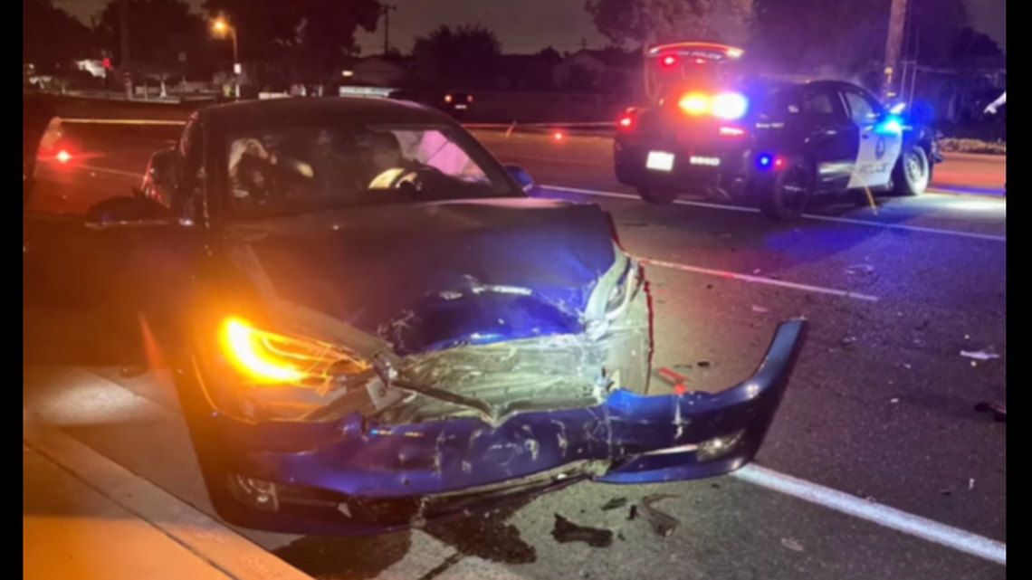 A Tesla in self-drive mode crashed into a cop car as its driver used their cellphone, California police say.