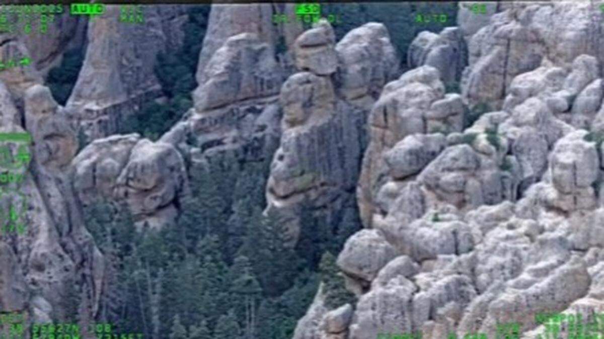 Two hikers were rescued after becoming stuck on cliffs in Utah, troopers said.