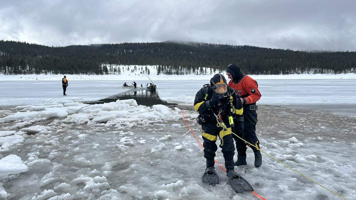 A diver helps search for the body of an ice fisherman reported missing after someone found his chair next to a hole in the ice on an Oregon reservoir.
