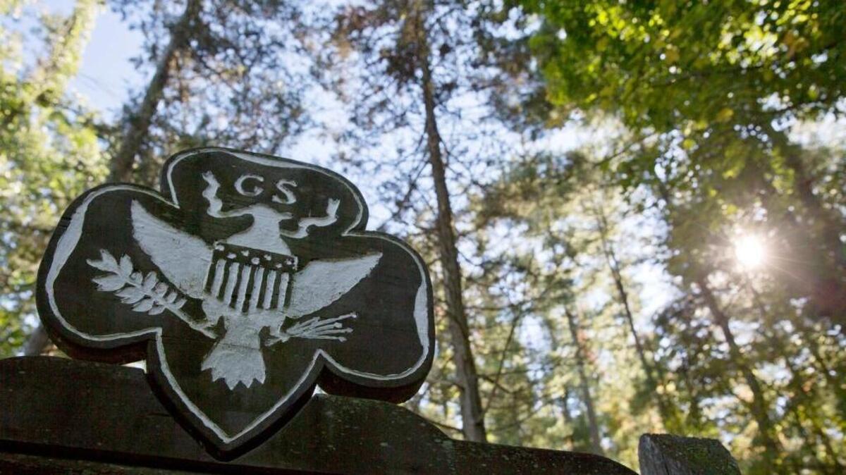 FILE - This Monday, Sept. 22, 2014 file photo shows the official Girl Scouts crest at the entrance of a Girl Scout Camp in Lapeer, Mich. A November 2017 PSA by the Girl Scouts encourages parents not to force their children to give hugs or kisses, even to relatives, to instill a healthy notion of consent.