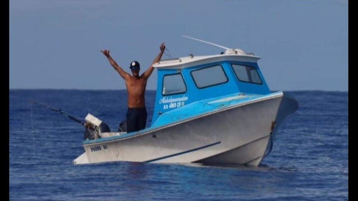 Earl Hind aboard his boat, Makalapua Onalani.