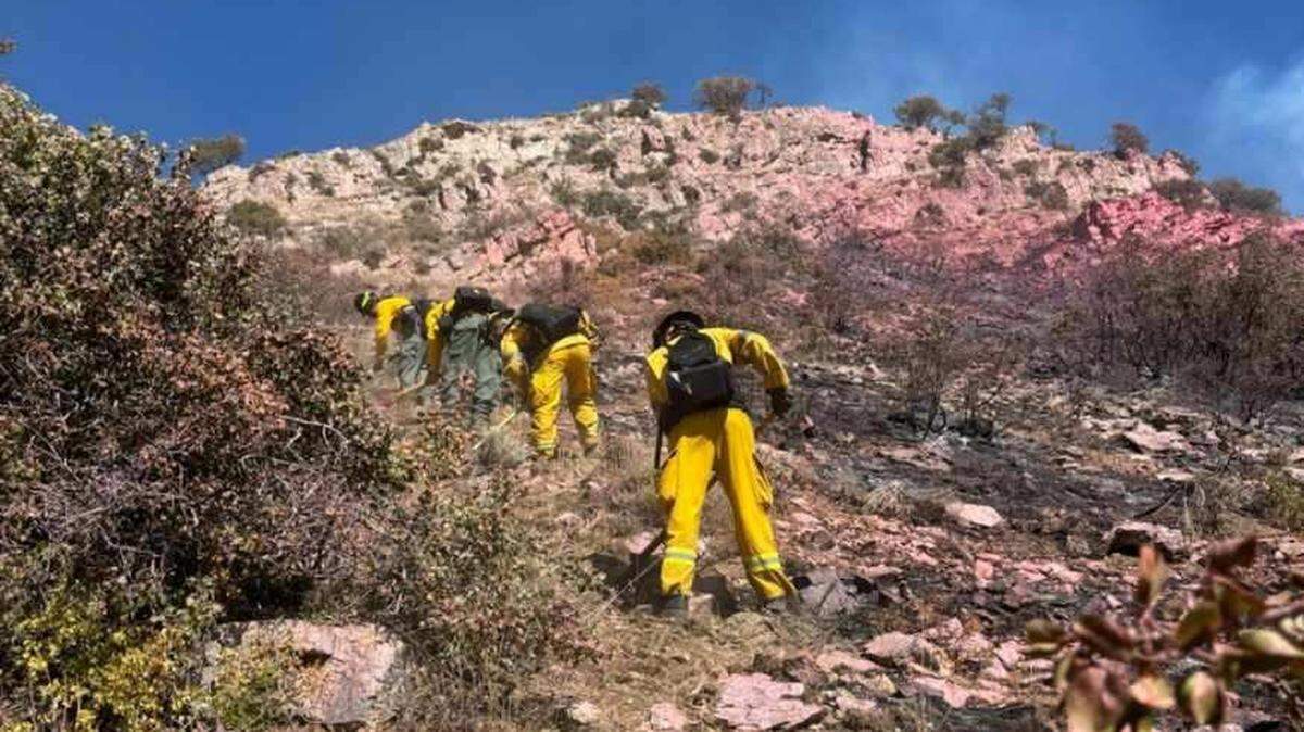 Firefighters battle a small wildfire sparked by a glider crash on Mahogany Mountain in Utah.