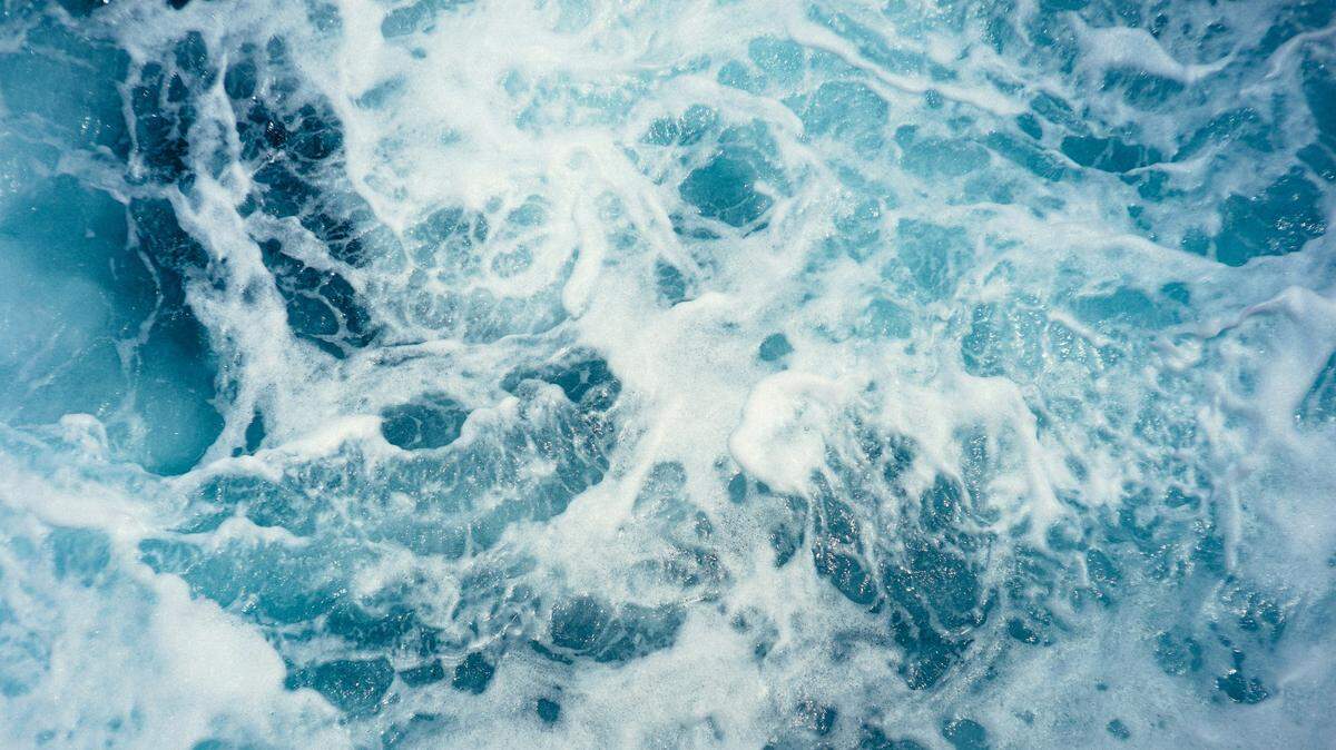 Onlookers called 911 while two women on the beach pulled the man to shore, firefighters said.