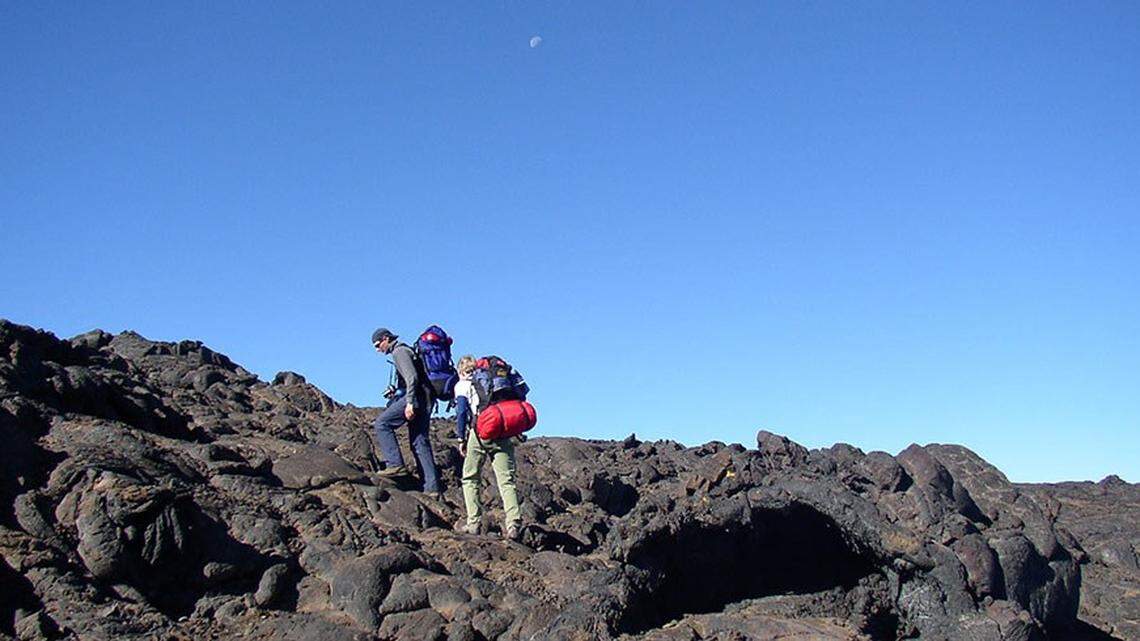 Hikers (not the ones pictured here) got lost while hiking Mauna Loa, the world’s largest active volcano, during a severe winter storm that closed the summit above 10,000 feet. They called 911 for help as their phones died and after they ran out of food and water.