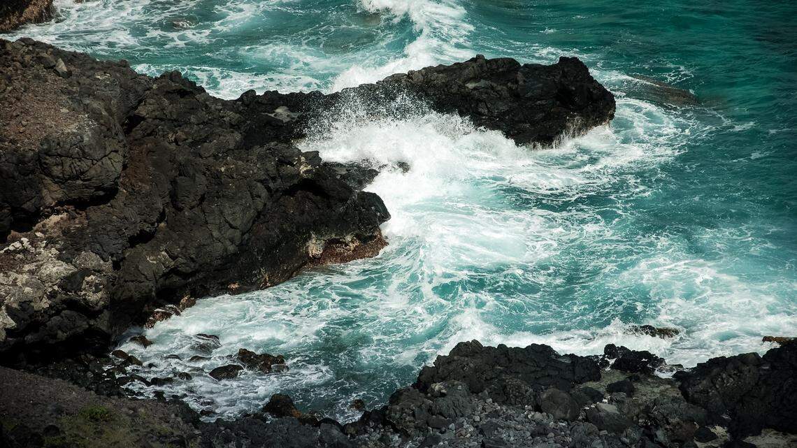 A tourist from Colorado was swept out to sea when a large wave hit him as he walked the rocky shore in Hawaii.