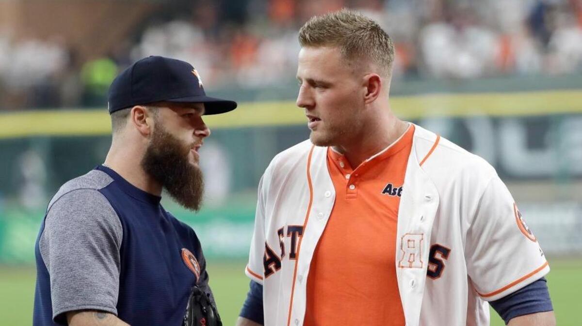 Houston Texans defensive end J.J. Watt, right, talks with Houston Astros pitcher Dallas Keuchel after throwing out the first pitch April 29 in Houston. Watt will do so again Friday, this time for Game 3 of the World Series.