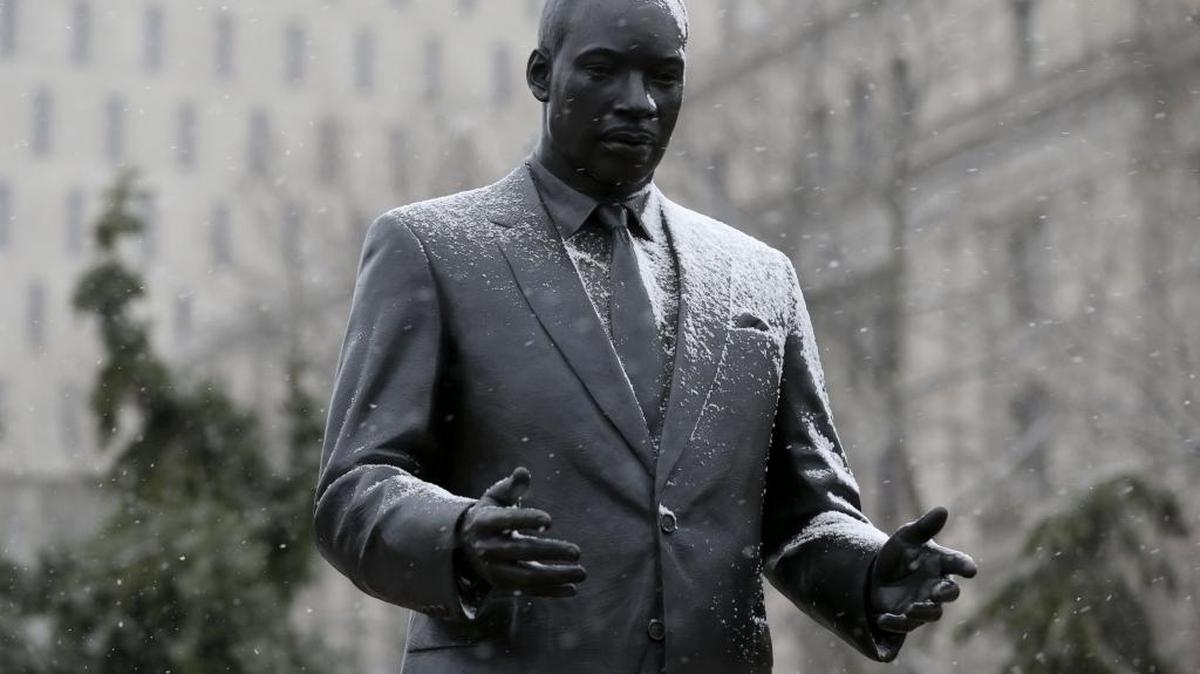 A light during of snow falls on a statue of Martin Luther King Jr. in Newark, N.J., Sunday, Jan. 17, 2016. A holiday honoring King’s birth is celebrated annually across the United States.