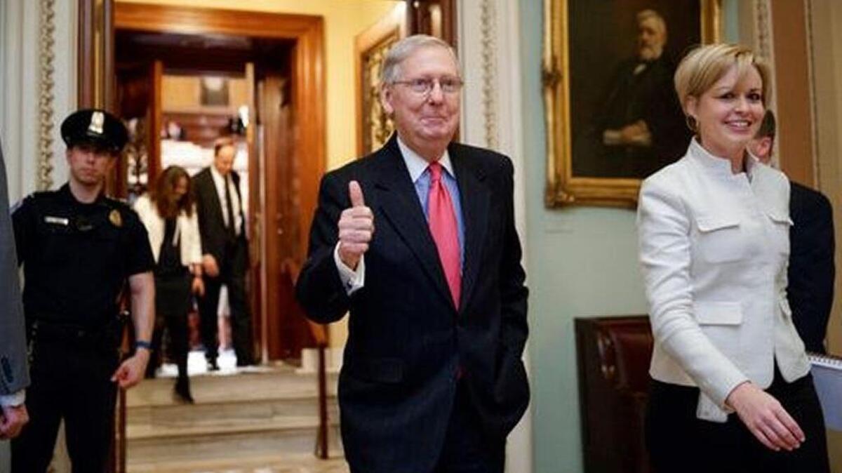 Senate Majority Leader Mitch McConnell of Kentucky signals a thumbs-up as he leaves the Senate chamber on Capitol Hill in Washington, Thursday, April 6, 2017, after he led the GOP majority to change Senate rules and lower the vote threshold for Supreme Court nominees from 60 votes to a simple majority in order to advance Neil Gorsuch to a confirmation vote.