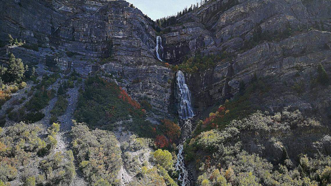 A woman suffered head and back injuries after being hit by a falling slab of rock at Bridal Veils Fall in Provo Canyon, Utah officials say.
