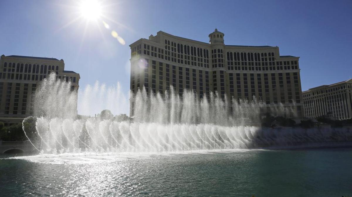In this Thursday, Aug. 14, 2014 photo, the sun shines on the fountains of the Bellagio, in Las Vegas.