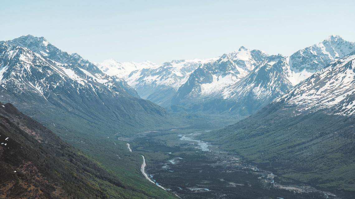 A photographer called for help after a paraglider vanished near Magnificent Peak in the Eagle River Valley, Alaska troopers say.