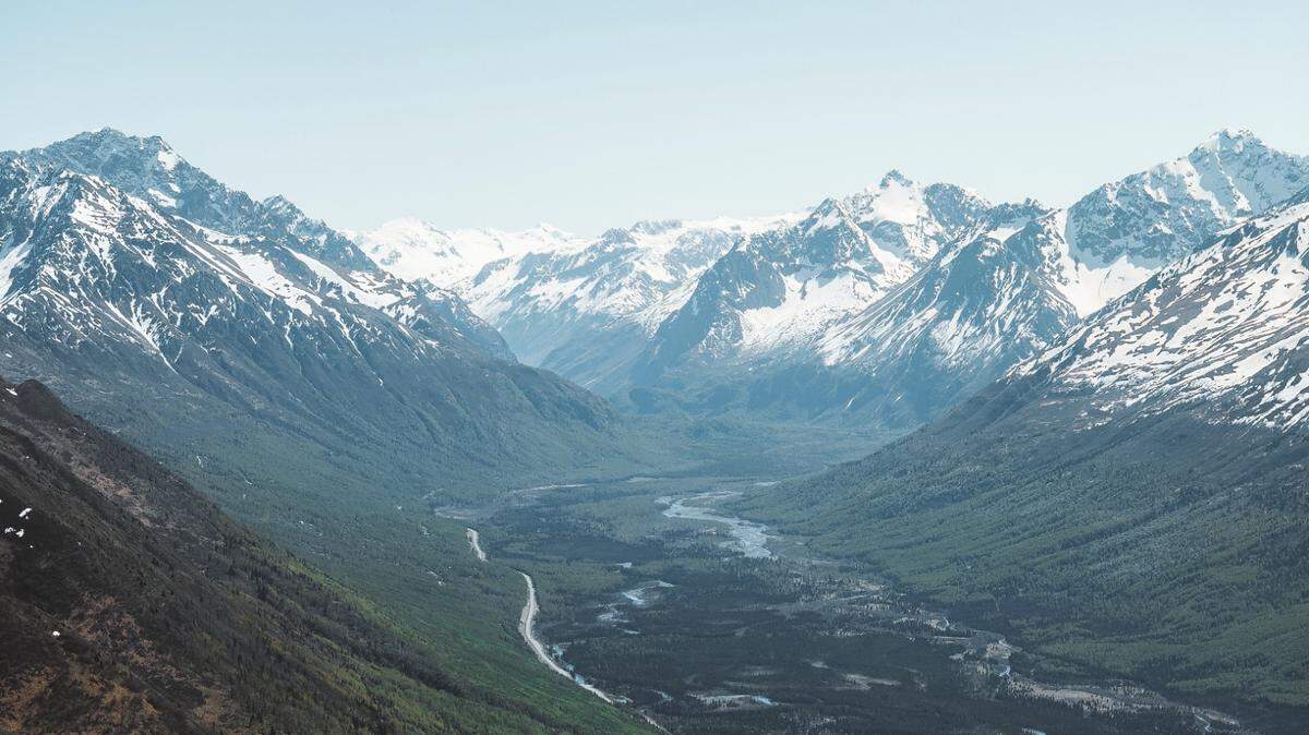 A photographer called for help after a paraglider vanished near Magnificent Peak in the Eagle River Valley, Alaska troopers say.