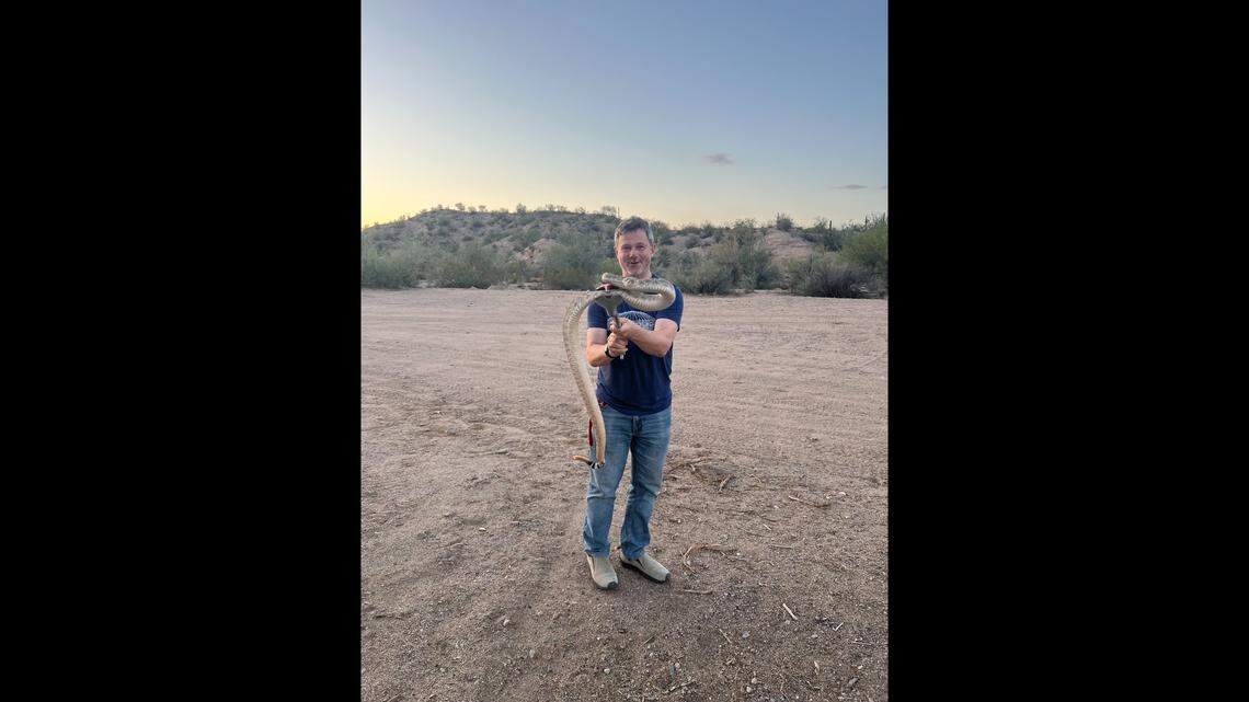 Wildlife biologist Ryan O’Donnell is pictured with a Western diamondback rattlesnake.