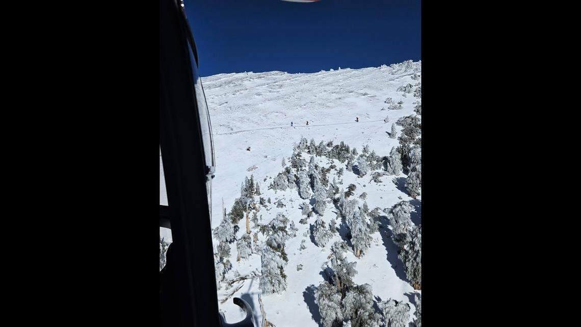 After they were lowered by helicopter, two rescuers “made their way to the hikers,” officials said.