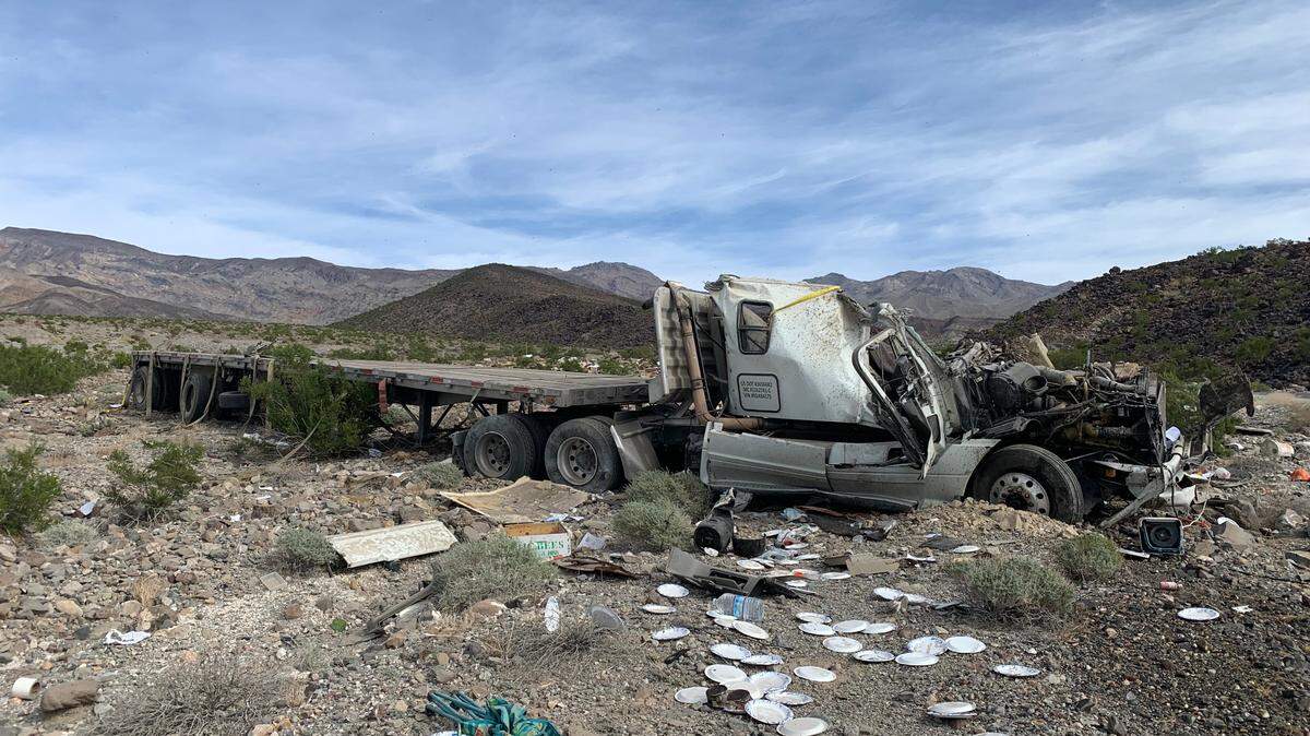 A driver and passersby who stopped to help him were stung by bees after a tractor-trailer carrying beehives crashed and rolled in Death Valley National Park.