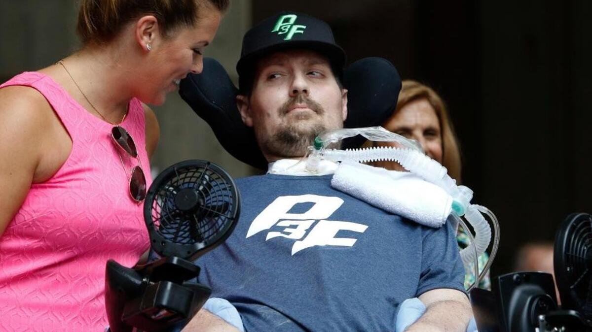 Pete Frates, who inspired the ice bucket challenge, looks at his wife, Julie, during a ceremony Tuesday at City Hall in Boston where Sept. 5 was declared Pete Frates Day by Boston Mayor Marty Walsh.