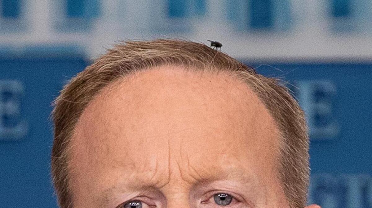 A fly lands on White House press secretary Sean Spicer as he talks to the media during the daily press briefing at the White House in Washington on Monday.