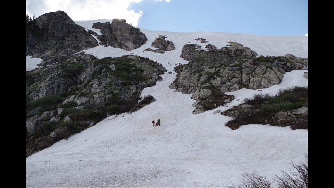 Rescuers trekked up to where the man had fallen, “about halfway down the slope into a cliff band area.”