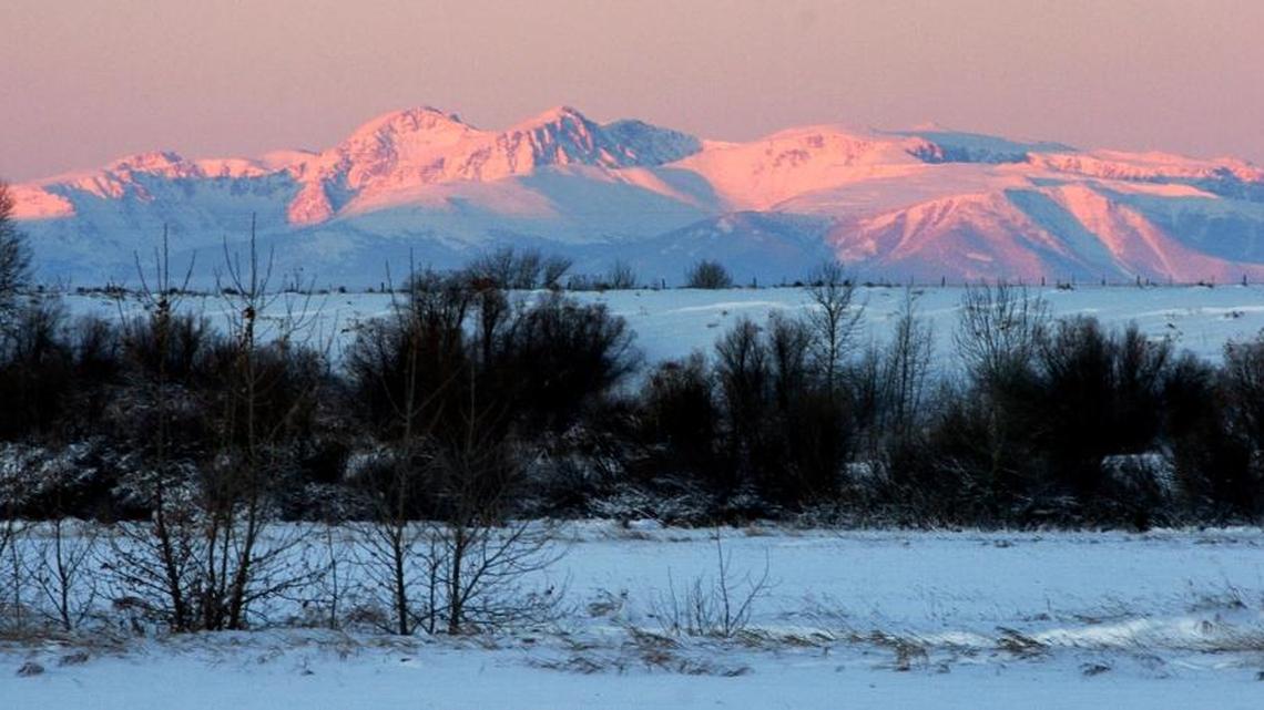The Beartooth Mountains glow in the morning light just after dawn southeast of Billings, Mont.