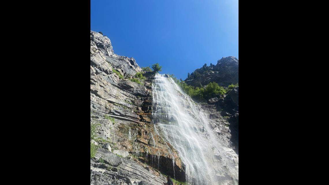 Rescuers lowered a hiker who injured his ankle on a slippery waterfall trail in Utah, photos show.