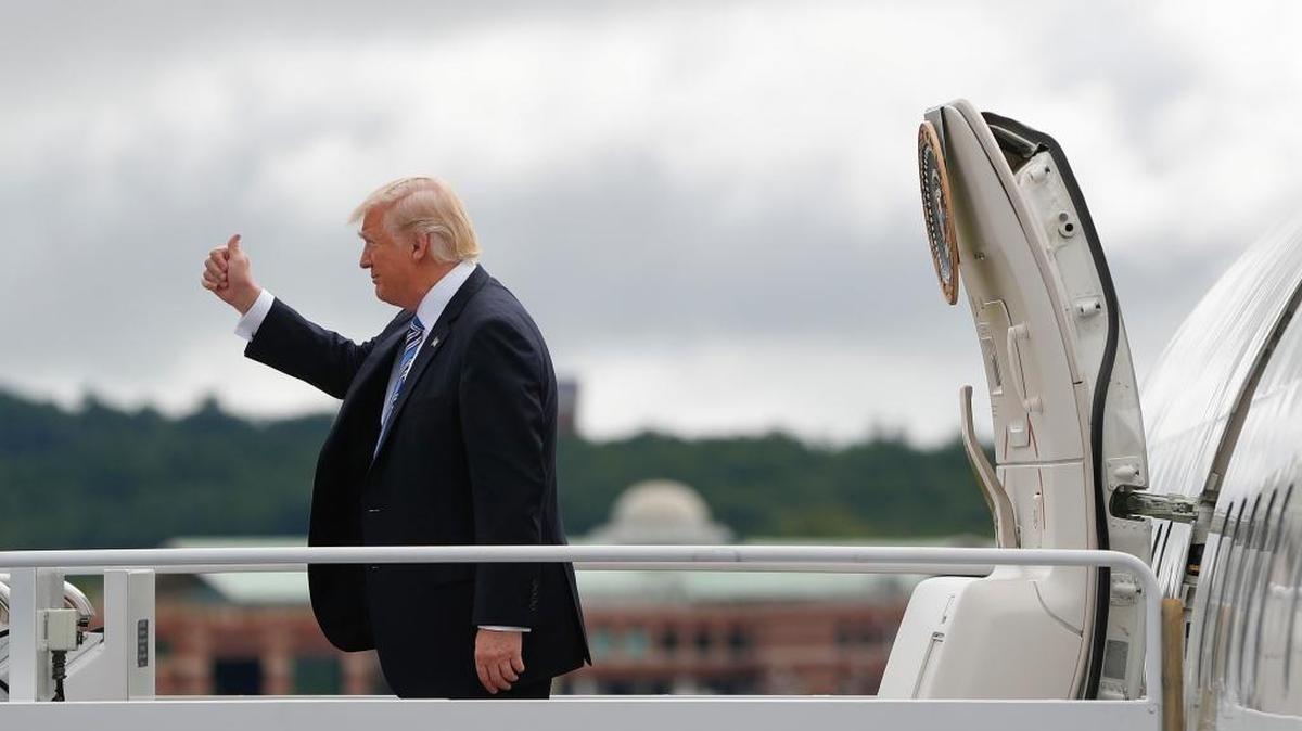 President Donald Trump gives a 'thumbs-up' as he steps out of Air Force One during his arrival at Lynchburg Regional Airport on Saturday in Lynchburg, Va.