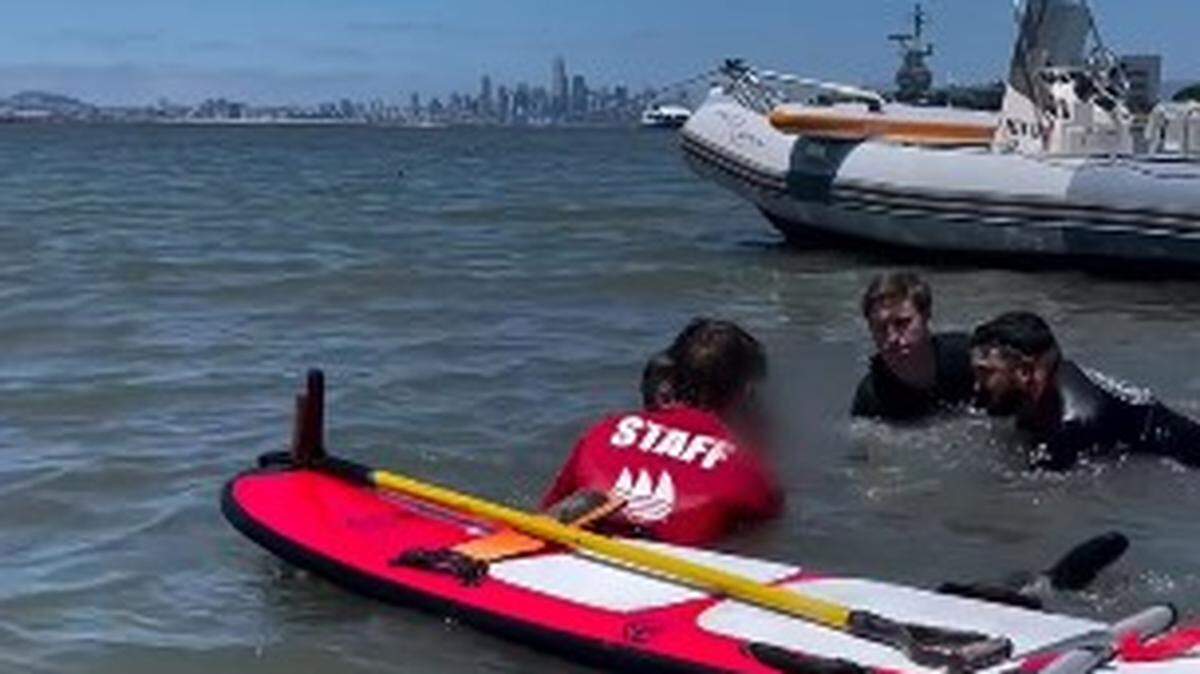 Rescuers work to save a teen stuck in rising tide on a beach near a California boat ramp.